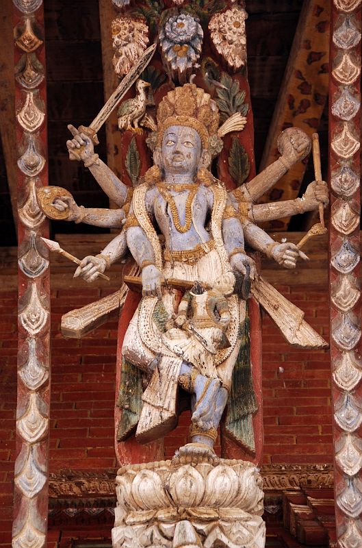 Kathmandu Changu Narayan 09 A Multi Armed Tantric Deity Carved In Wood On The Roof Strut Of Changu Narayan Temple The double-roofed Changu Narayan Temple in the Kathmandu Valley has intricate roof struts with multi-armed Tantric deities, masterpieces of Newari carving.